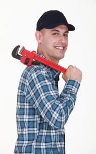 Jack is posing for a photo with his big red wrench